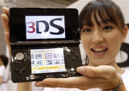 Model poses with Nintendo Co Ltd's new 3DS handheld game console in Chiba